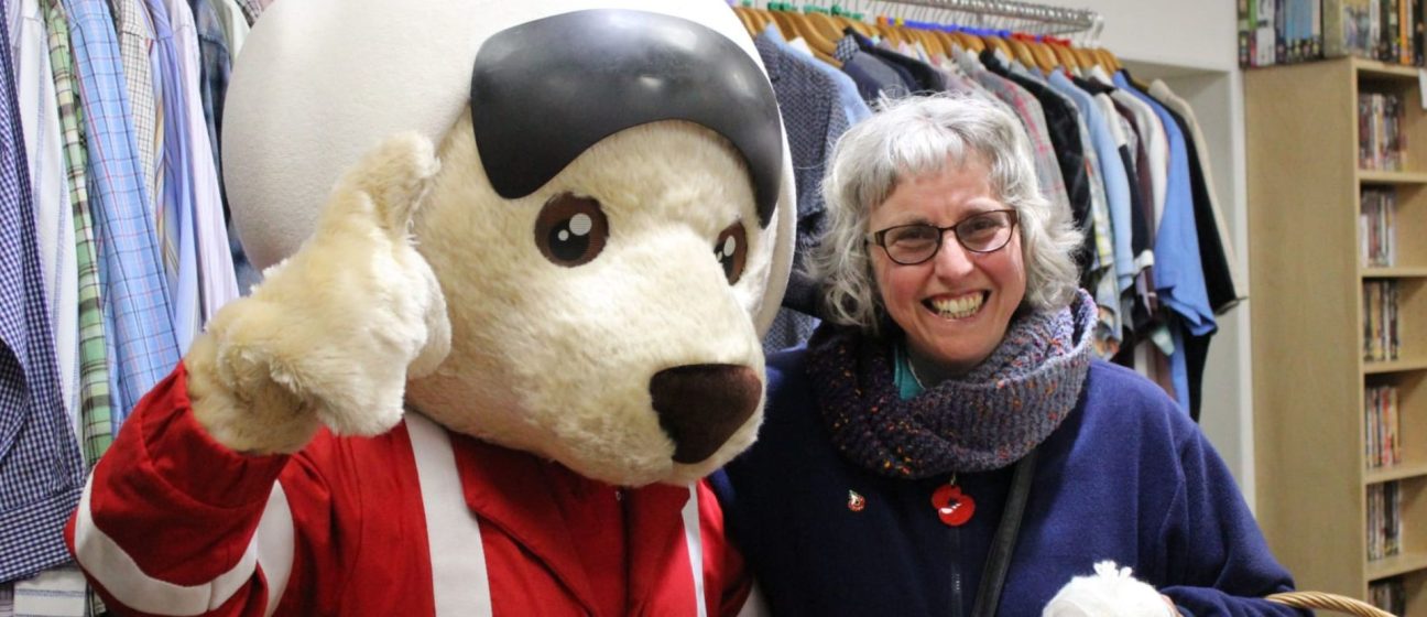 Volunteer with DAA mascot, Ambrose bear