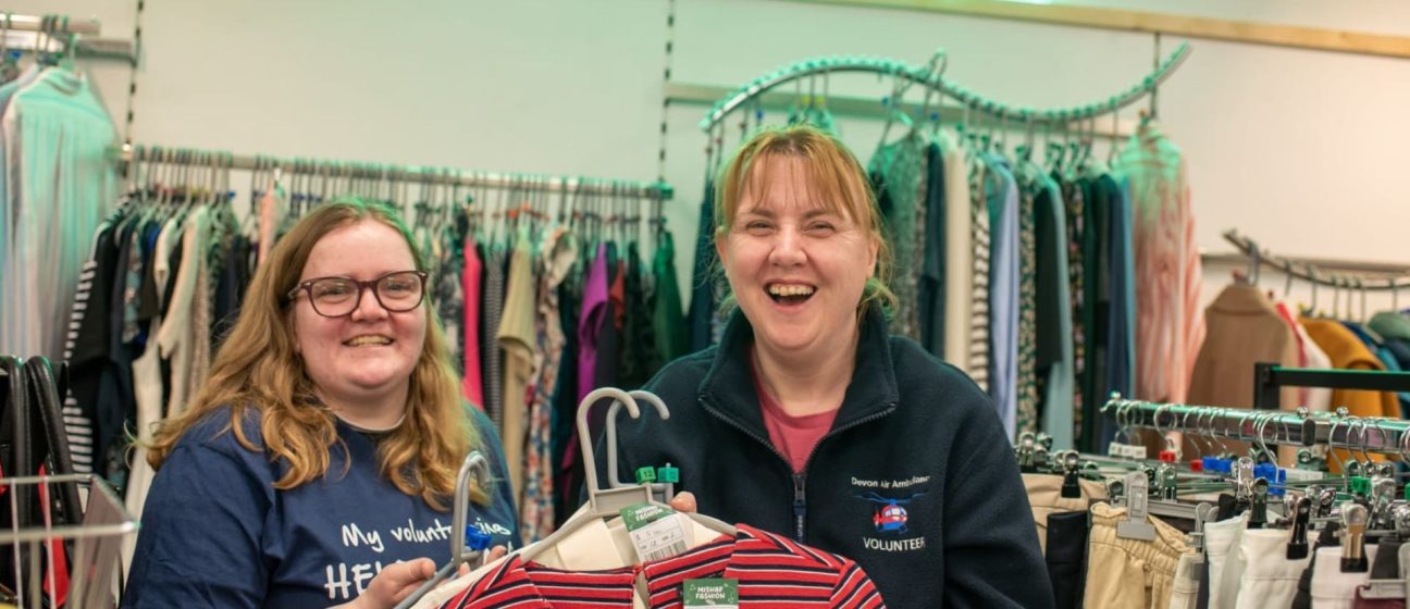 Two happy shop volunteers