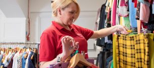 Volunteer adding clothes to rails