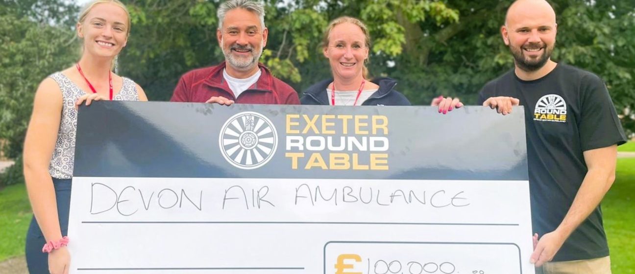 Exeter Round Table and Devon Air Ambulance team with £100k cheque