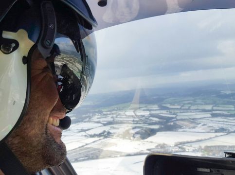 Pilot flying over snowy landscape