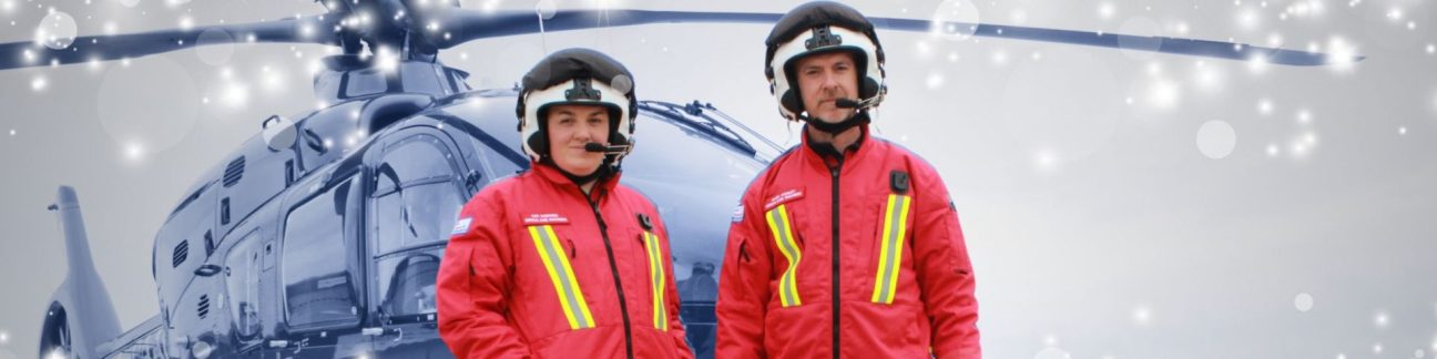 Christmas Appeal - pilots in front of helicopter