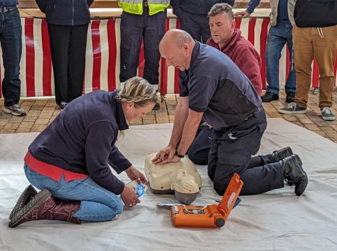 A member of our crew demonstrates CPR using an AED.