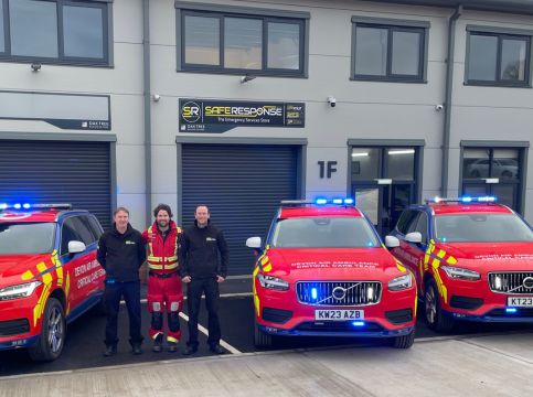 Crew member Lee Hilton with Safe Response staff and two new critical care cars.