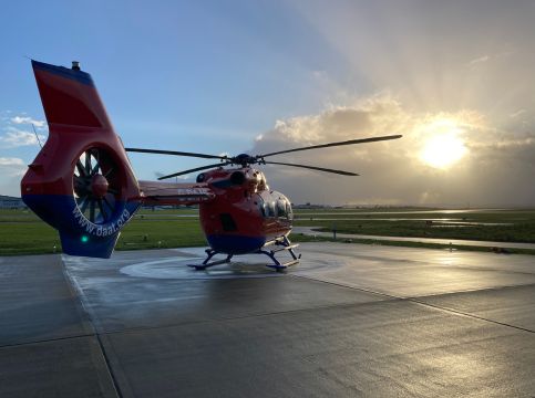 Aircraft on helipad with sunset