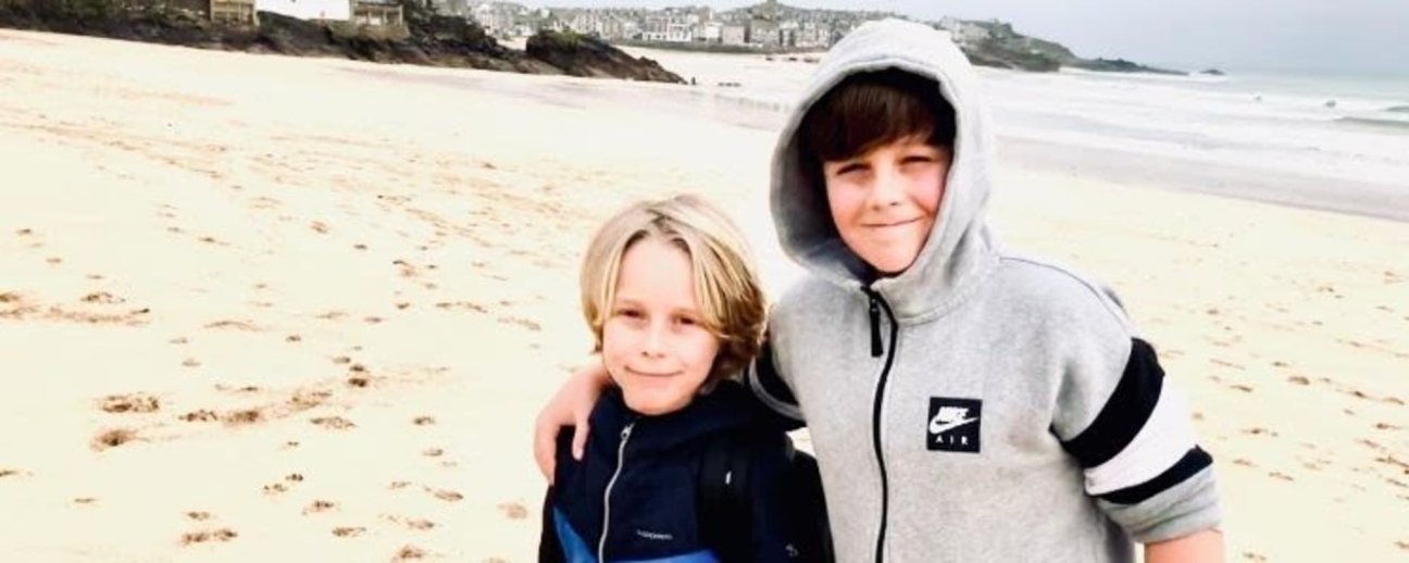 Patient Noah with his brother on the beach